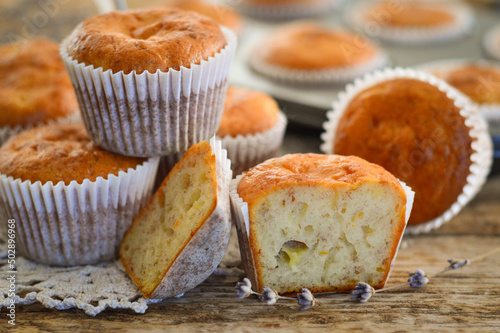 Homemade muffins. Muffins in baking molds. Muffins on a wooden background.