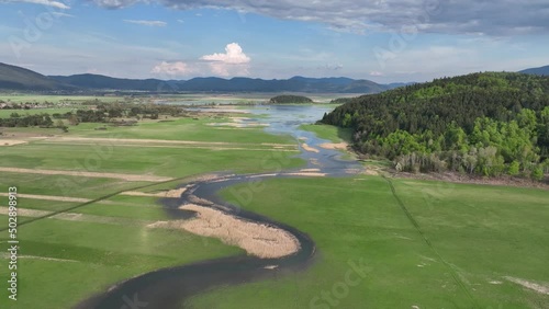 Flying over the Cerknica lake on a beautiful spring day. The river goes from the forest to the flatlands where it creates an intermittent lake. photo