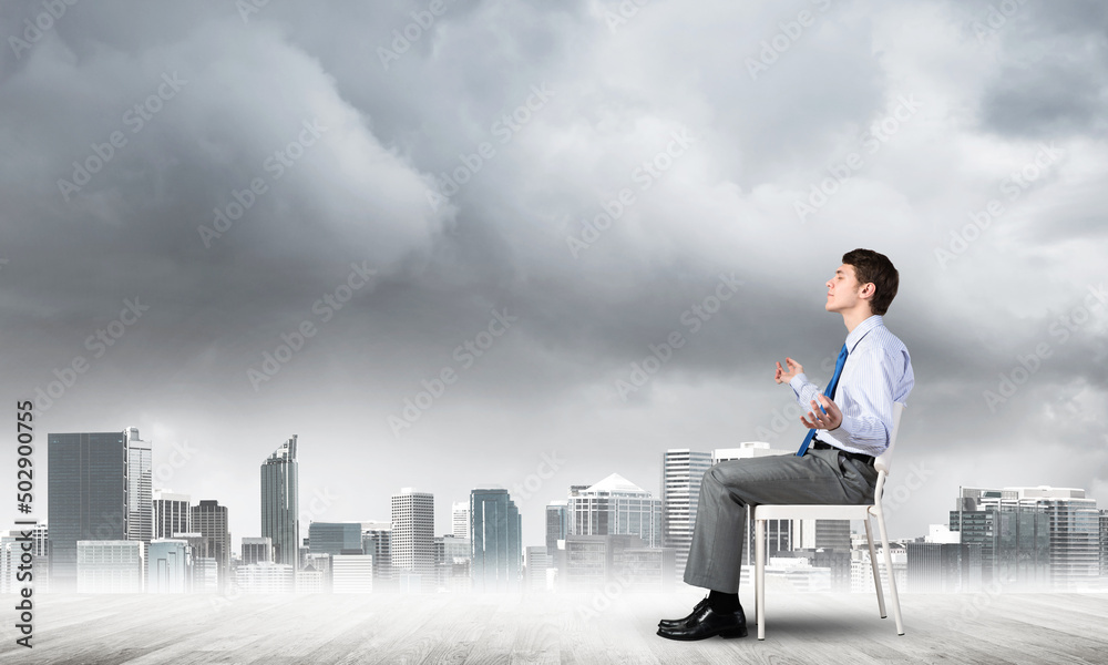 businessman meditates on office chair businessman meditates on office chair