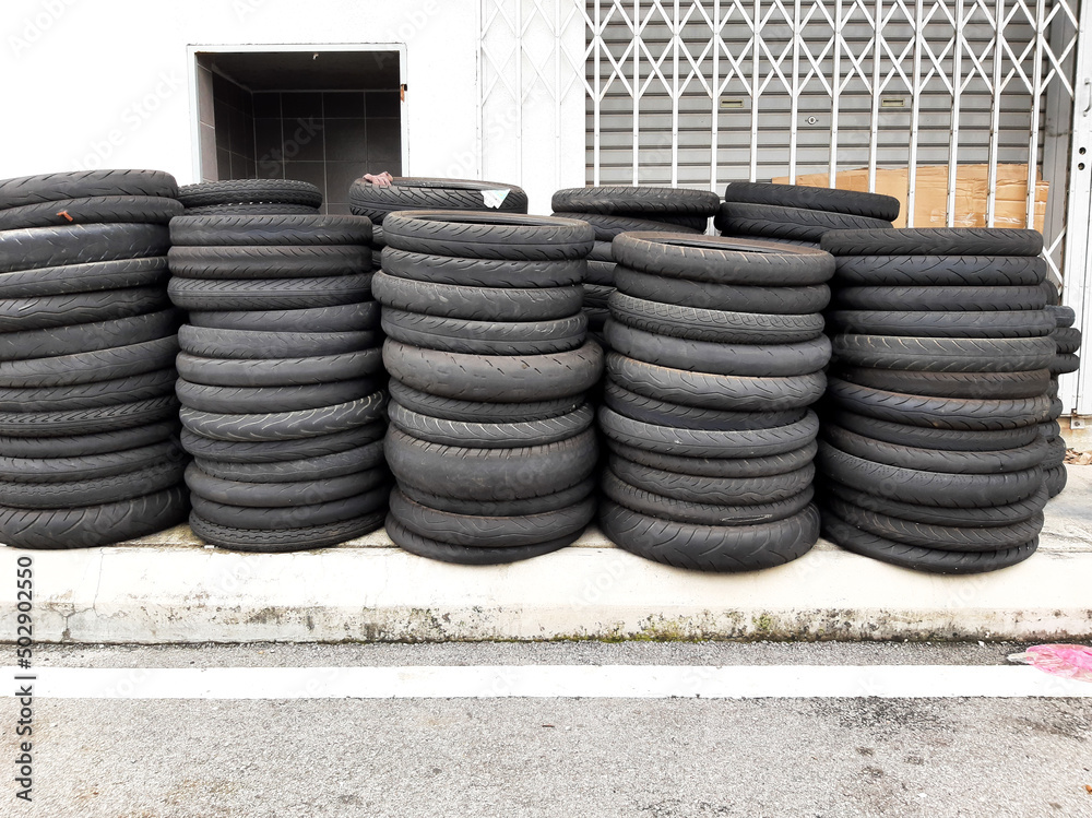 Selective focus with noise effect picture of used motorcycle tyre been stacked outside of the shop. Selective focus with noise effect picture of used motorcycle tyre been stacked outside of the shop.