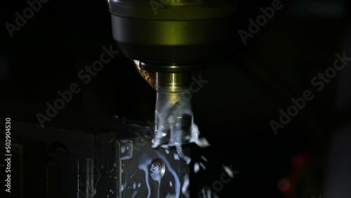 Industrial metalworking cutting automation process by milling CNC.Micro machining process , Coolant and lubrication.Close up of CNC machine at work.