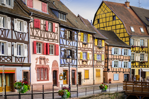 historical wooden half-timbered architecture of the alsace town on the river bank