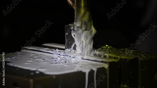 Industrial metalworking cutting automation process by milling CNC.Micro machining process , Coolant and lubrication.Close up of CNC machine at work.