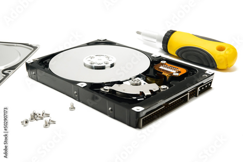 Open hard drive and screwdriver isolated on white background closeup. Computer hard drive HDD. computer memory