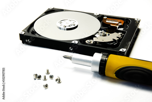 Open hard drive and screwdriver isolated on white background closeup. Computer hard drive HDD. computer memory