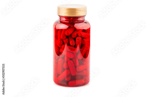 Prescription drugs flowing from red capsule bottle isolated on white