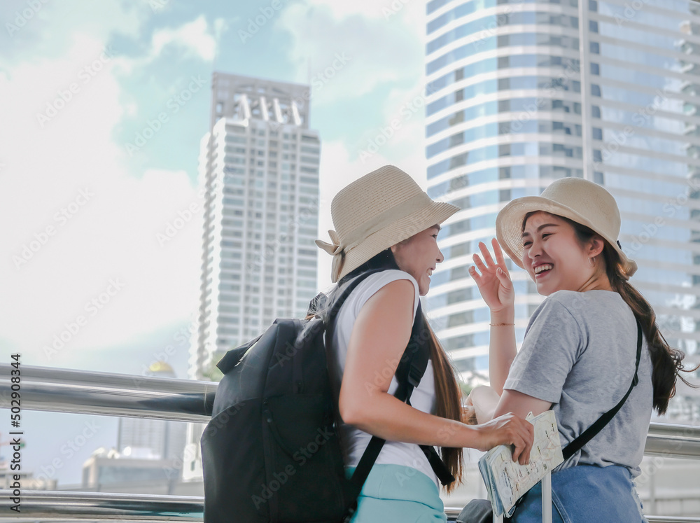 Couple backpackers with suitcase are smiling in happy moments at Bangkok city outdoor, inspirational travel concept. Couple backpackers with suitcase are smiling in happy moments at Bangkok city outdoor, inspirational travel concept.