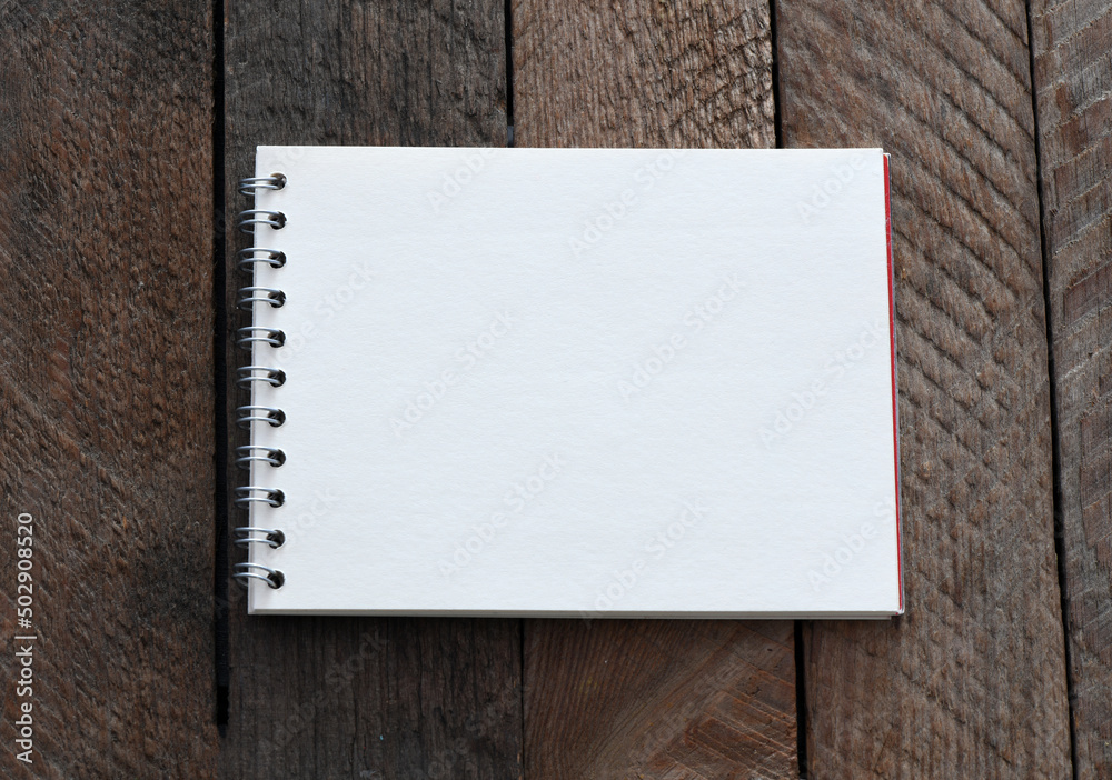 Blank notepad and coffee cup on office wooden table Blank notepad and coffee cup on office wooden table