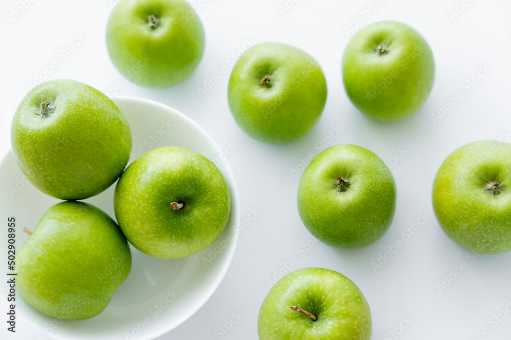 top view of bowl with organic apples on white. top view of bowl with organic apples on white.