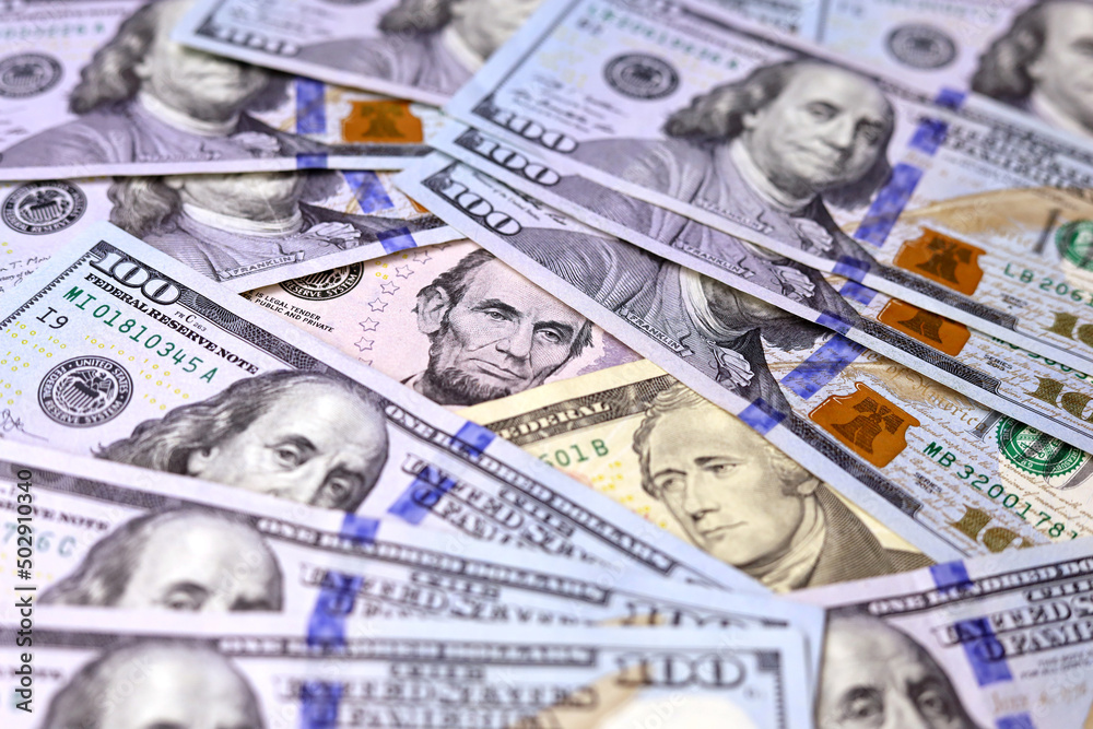 Fototapeta premium US dollars banknotes of different denominations, paper currency for background. Concept of american and global economy, exchange rate