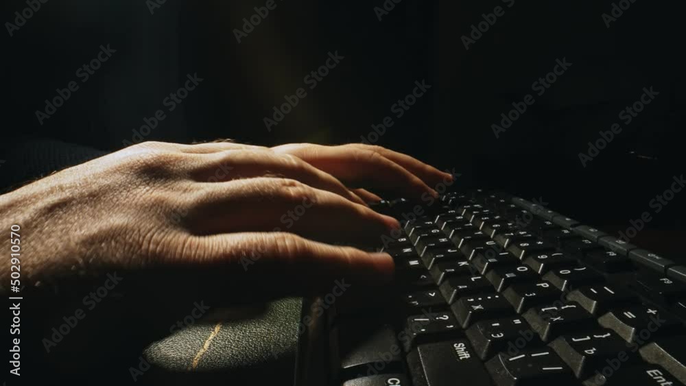 Man is typing on a keyboard.