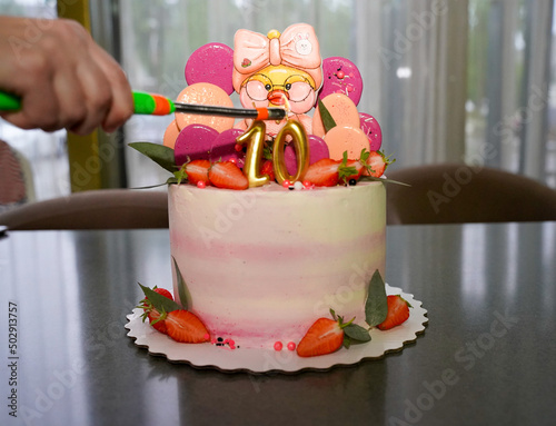 Lights a candle on the cake on the day