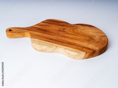 Cutting board made of solid teak wood on a white background