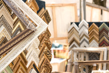 Variety of wooden and plastic picture frames in different colours and sizes. Custom picture and arts framing service