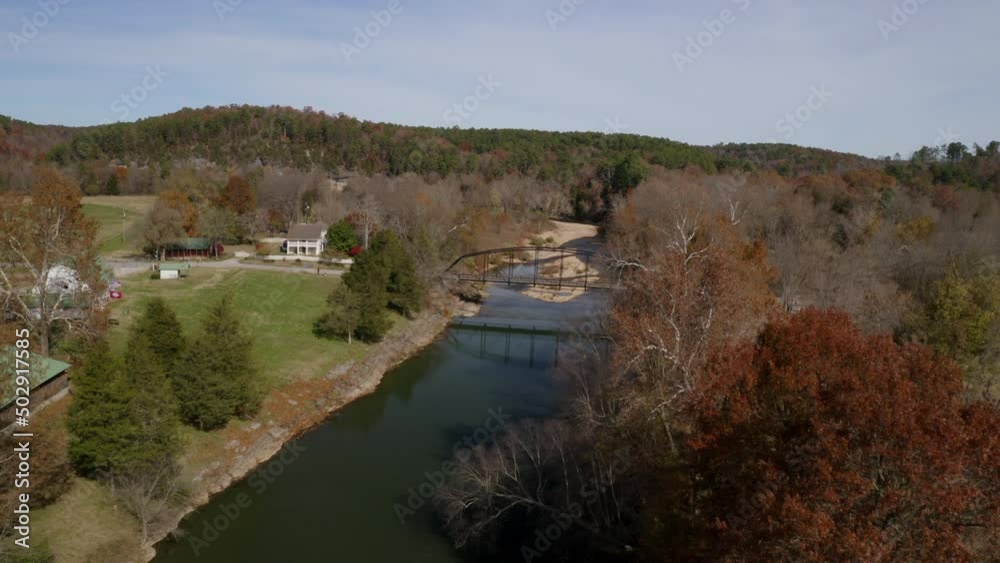 Aerial Forward Shot Of War Eagle Mill Bridge Over River Amidst Hills - Rogers, Arkansas Aerial Forward Shot Of War Eagle Mill Bridge Over River Amidst Hills - Rogers, Arkansas