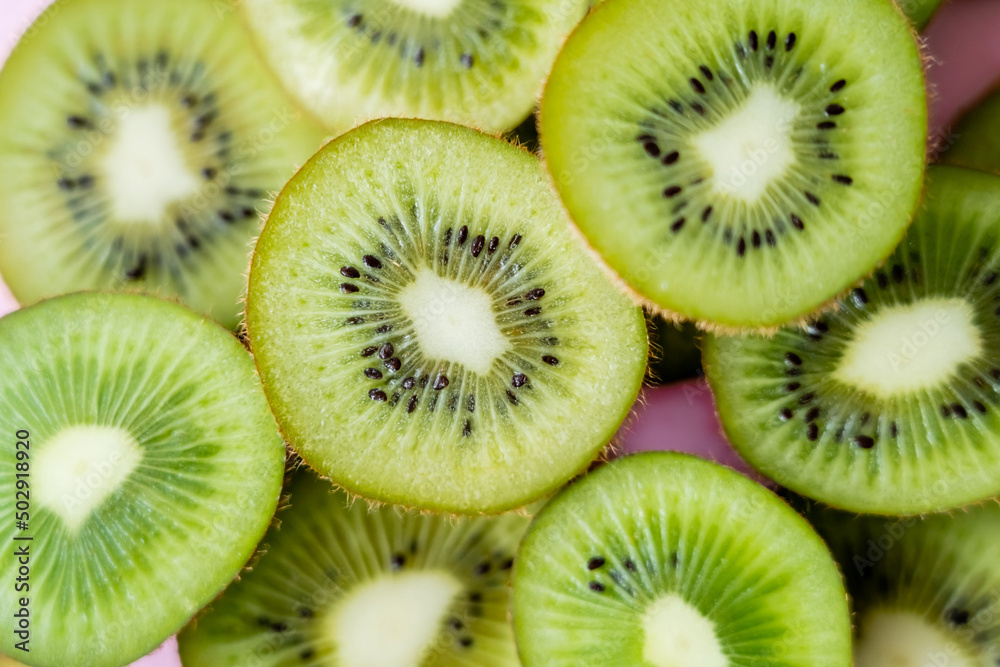 top view of sliced fresh kiwi on pink, close up. top view of sliced fresh kiwi on pink, close up.