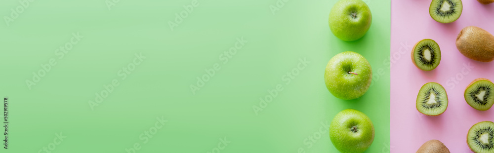 top view of rows with apples and kiwi fruits on green and pink, banner. - obrazy, fototapety, plakaty 