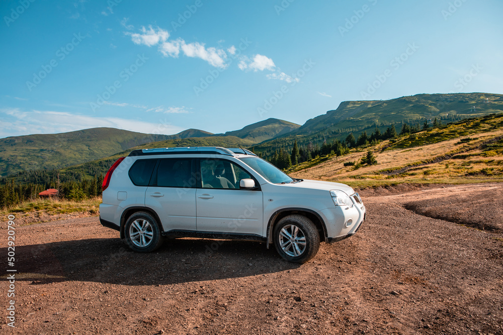 suv car on the top of ukraine carpathian mountain range