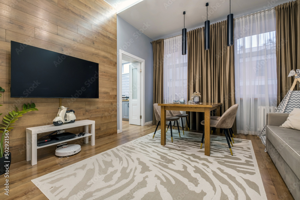 Fototapeta premium served table in the living room or kitchen with cups, plates, glasses and flowers