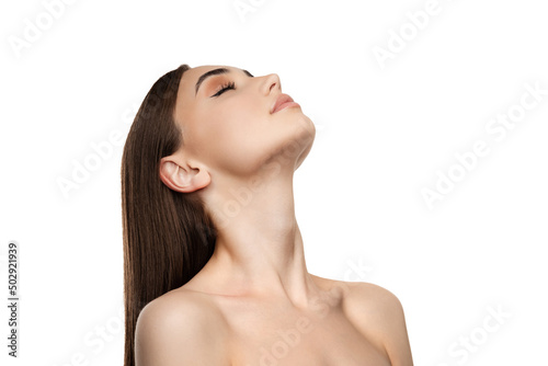 Portrait of beautiful young woman with straight brown hair posing with eyes closed isolated over white studio background