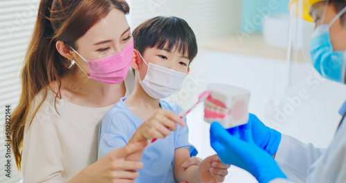 dentist teach boy brush teeth