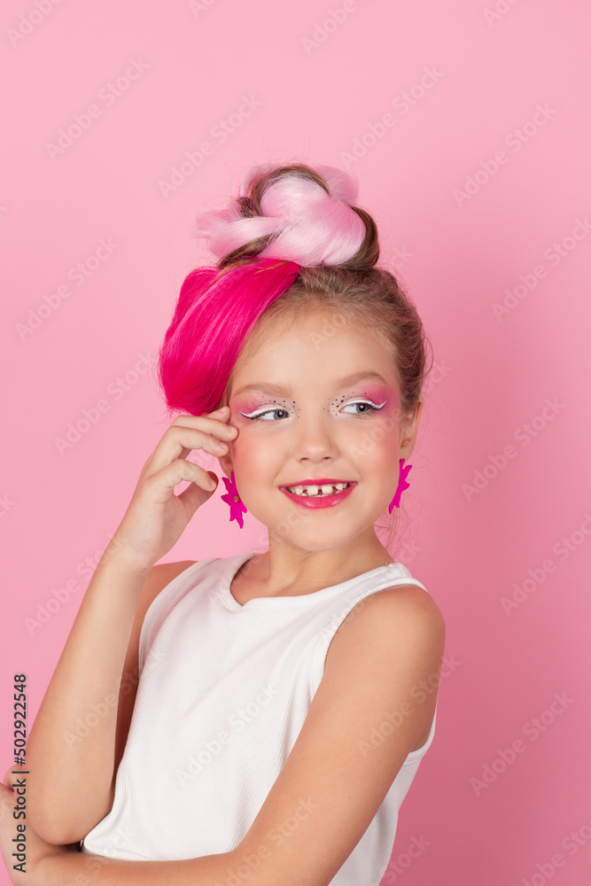 charming little girl with pink hairstyle and pink makeup. tween young model posing on pink background charming little girl with pink hairstyle and pink makeup. tween young model posing on pink background
