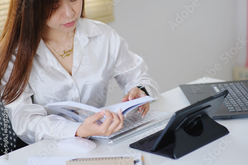 Woman in modern office  reading a business book