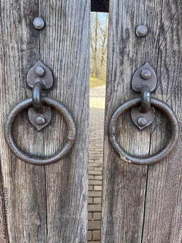 Old door handles on the wooden door 