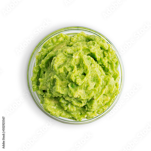 Top view of traditional mexican dip, sauce, spread or salad made of mashed ripe green avocado served in glass bowl as snack or appetizer for vegan or vegetarian dieting isolated on white background