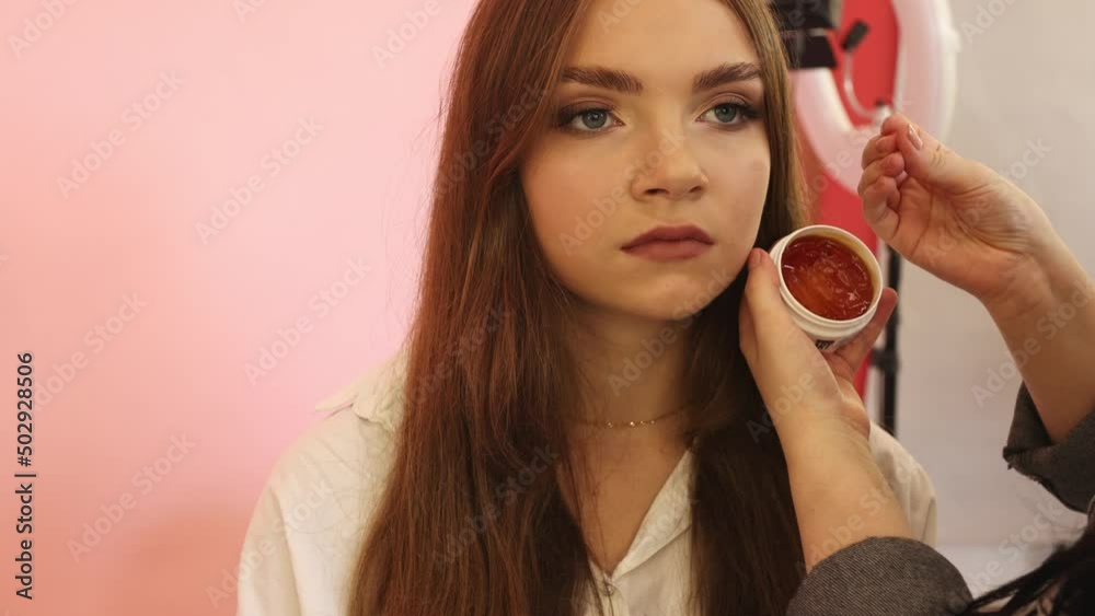 Demonstration of smooth and silky brunette hair after straightening it with a steampod. The master shows hair gel, a lock of smooth, shiny and silky brunette hair after straightening Demonstration of smooth and silky brunette hair after straightening it with a steampod. The master shows hair gel, a lock of smooth, shiny and silky brunette hair after straightening