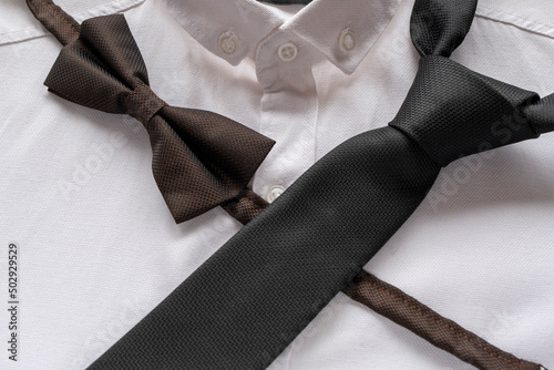 Black tie and bow tie on white shirt, men fashion concept, black color accessories,  men clothing idea, sitting view