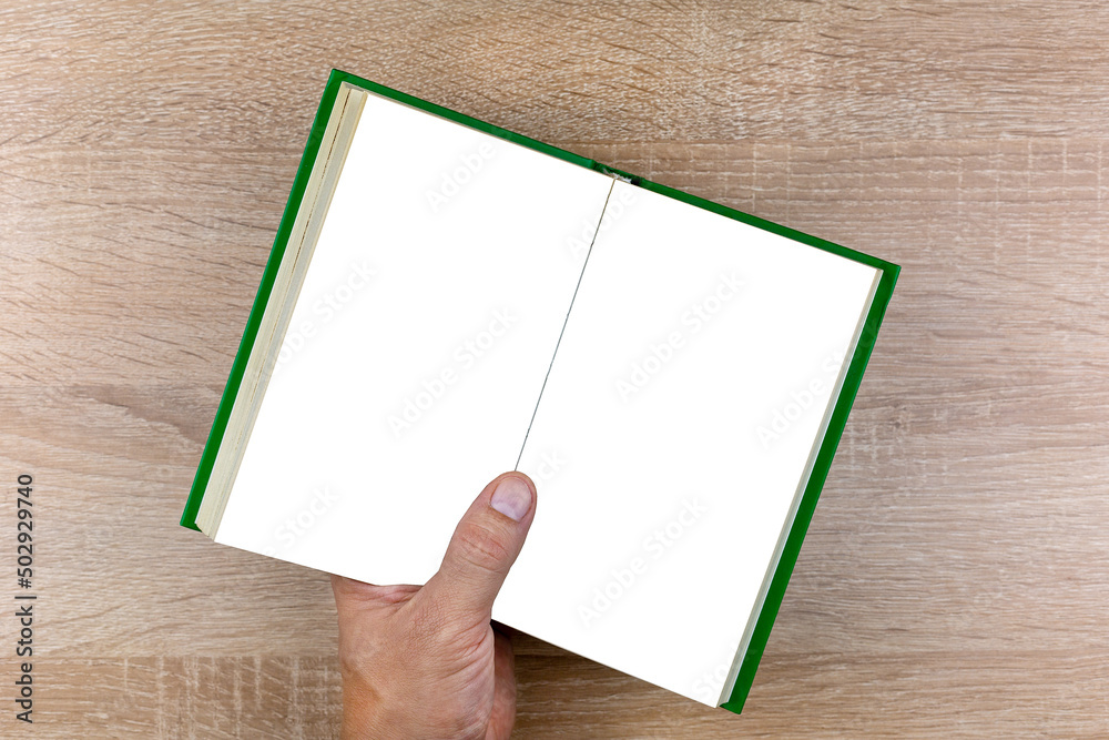 Man hand holds open book with blank pages. Man hand holds open book with blank pages.