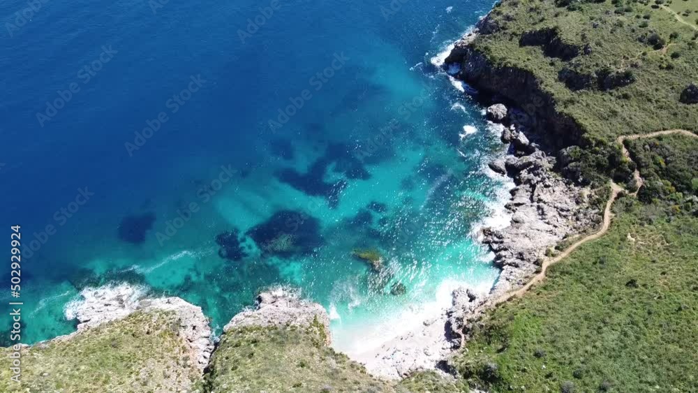 Stunning bay with crystal clear turquoise water at Zingaro on the island of Sicily in Italy, sunny weather (drone shot) Stunning bay with crystal clear turquoise water at Zingaro on the island of Sicily in Italy, sunny weather (drone shot)