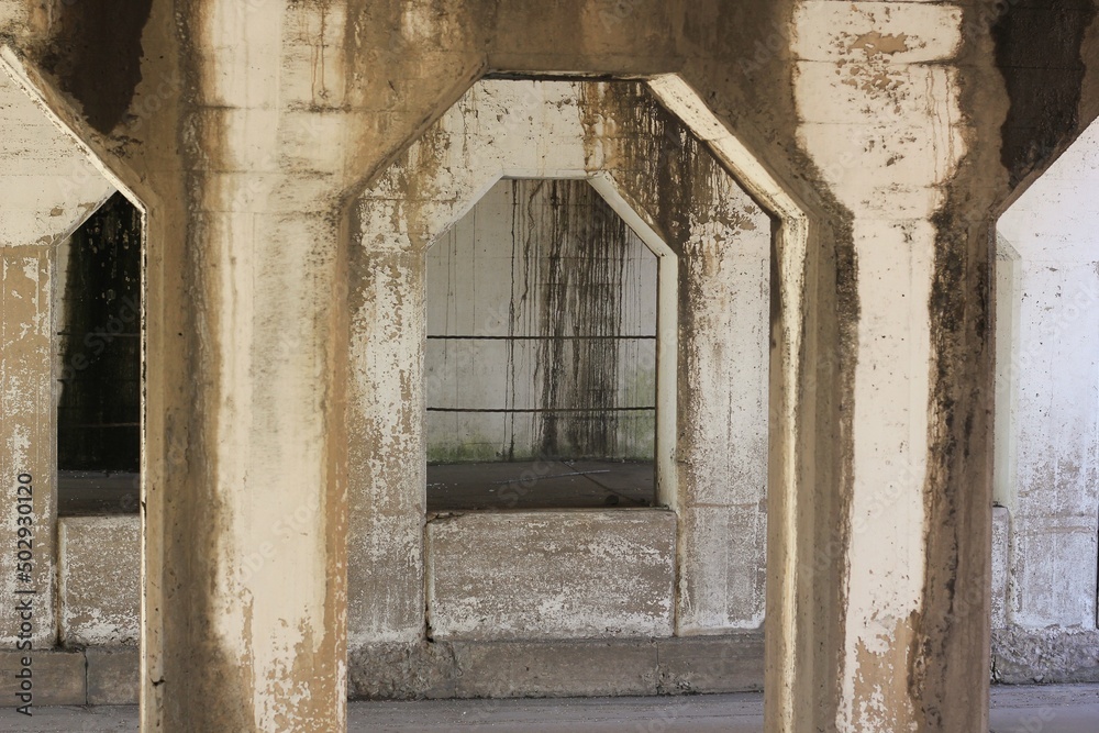Old concrete arch supporting an urban structure.
