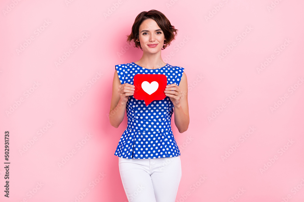 Photo of pretty young brunette lady hold heart wear blouse jeans isolated on pink color background Photo of pretty young brunette lady hold heart wear blouse jeans isolated on pink color background