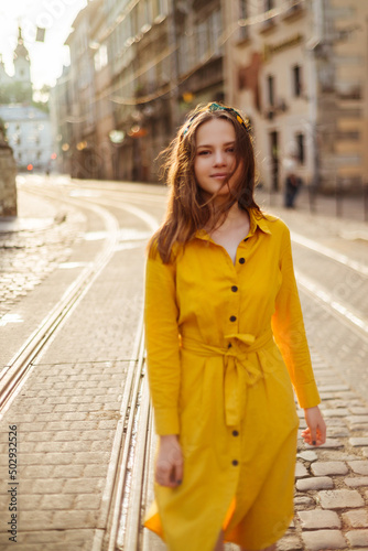 Pretty girl in yellow dress on city street