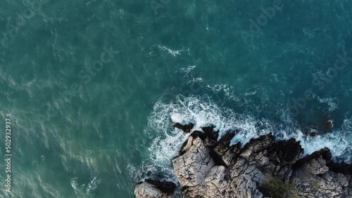 Storm at sea. View from the top. Blue Sea. Rocks and huge waves. High quality 4k footage