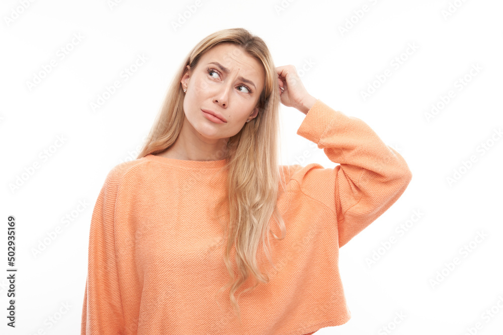 Smart blonde girl in casual holding her head thinks doubts, makes decision isolated on white studio background Smart blonde girl in casual holding her head thinks doubts, makes decision isolated on white studio background