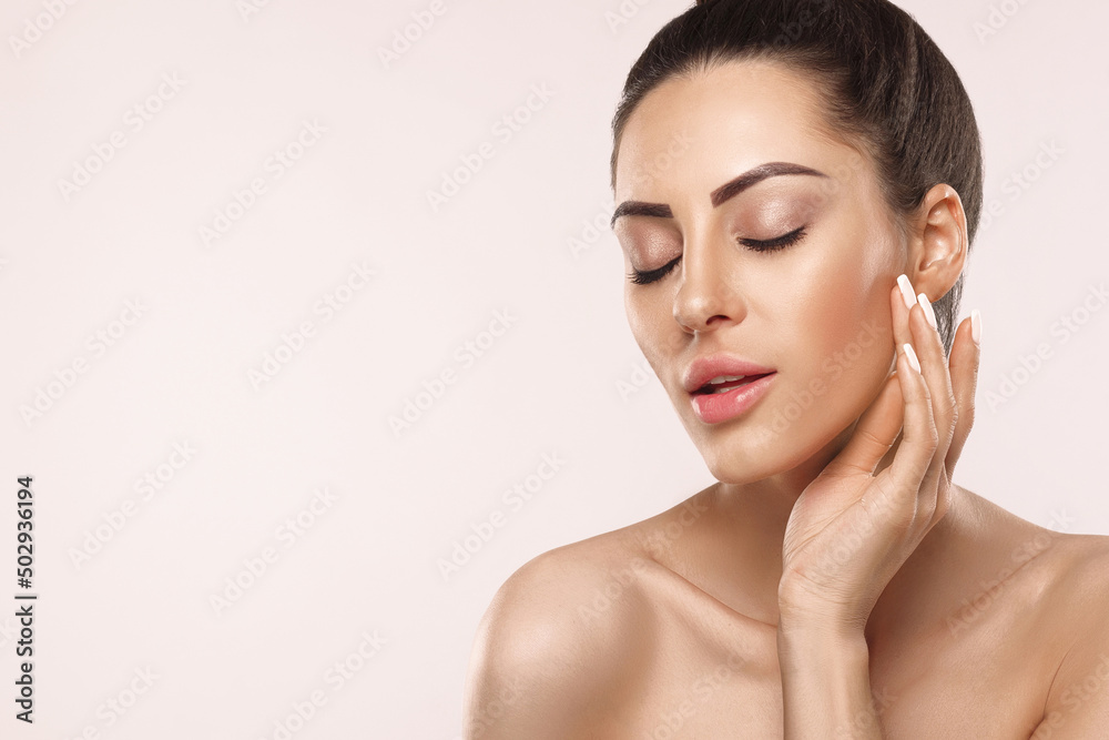 Skin care. Cute Woman with beauty face touching healthy facial skin portrait. Beautiful smiling girl model with natural makeup touching skin