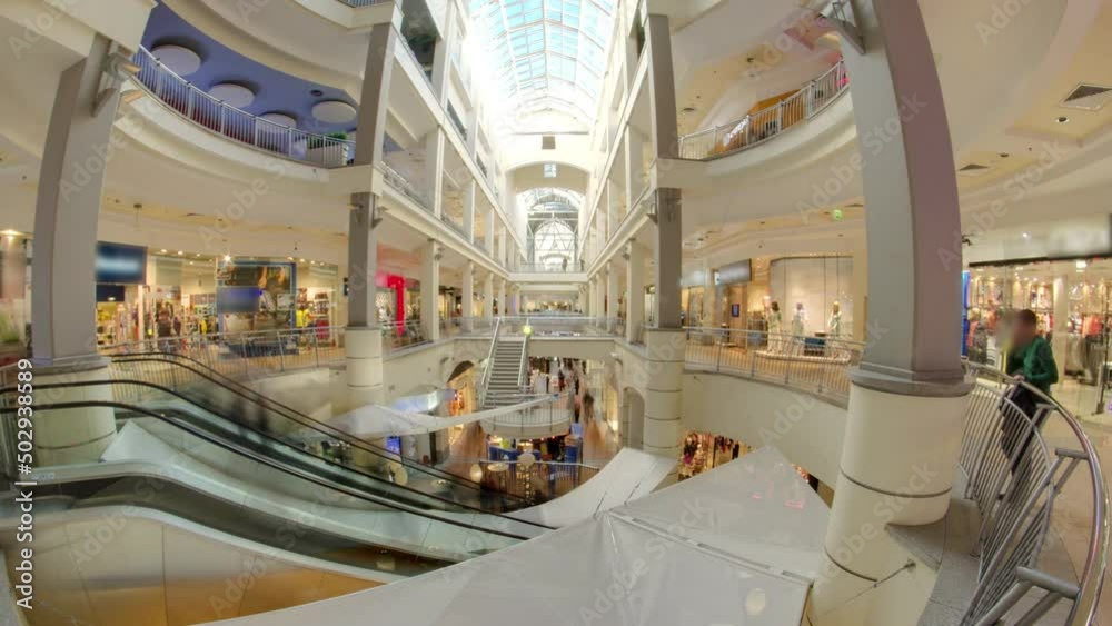 Many shops in multi-level department store or shoping mall timelapse hyperlapse. Escalator between floors