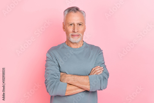 Photo of funny confident man pensioner dressed grey shirt arms folded isolated pink color background