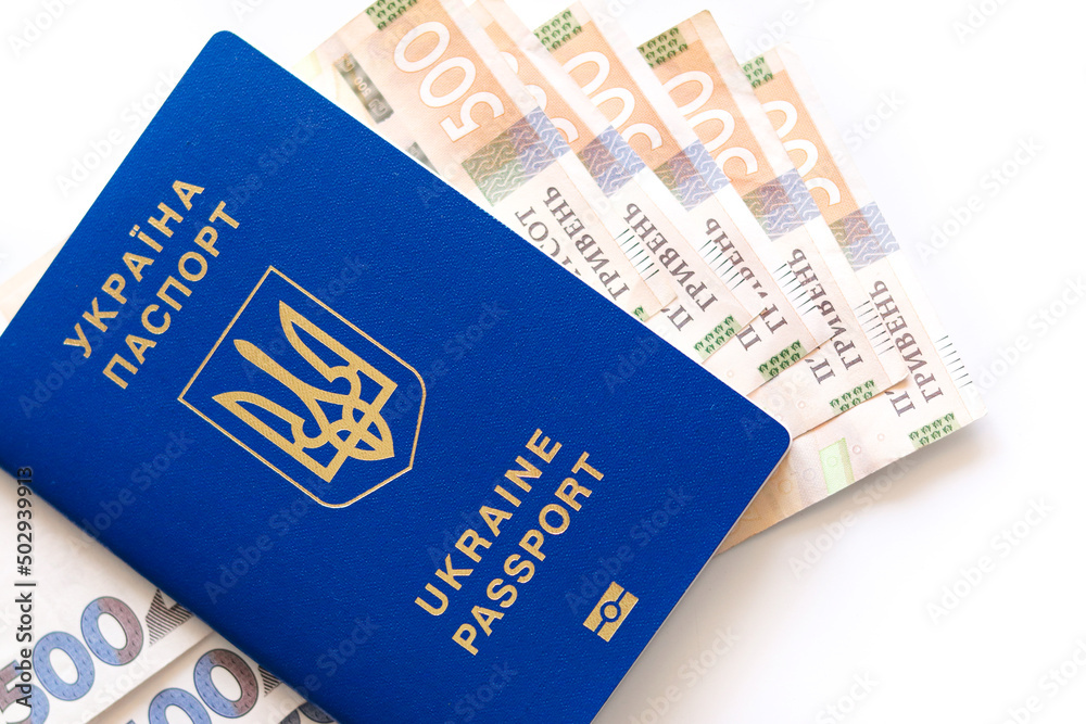 Ukrainian biometric passport. Ukrainian international passport with money isolated on a white background.