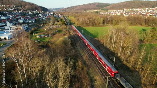 Aerial drone view of a train on the Deutsche bahn, spring, sunset in Hesse, Germany photo