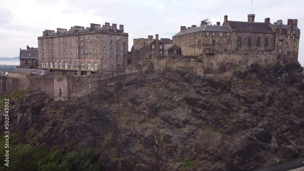 Drone view of Edinburgh Castle with impregnable walls on a stone cliff. Drone view of Edinburgh Castle with impregnable walls on a stone cliff.