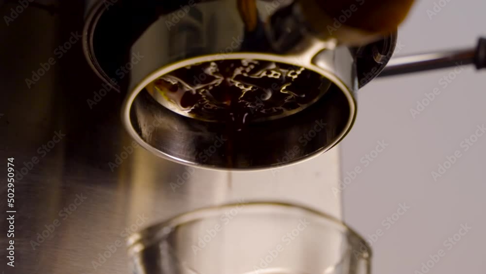 Close up slow motion of Pouring coffee stream from professional machine , Crema Espresso Perfect Shot from coffee maker machine Close up slow motion of Pouring coffee stream from professional machine , Crema Espresso Perfect Shot from coffee maker machine