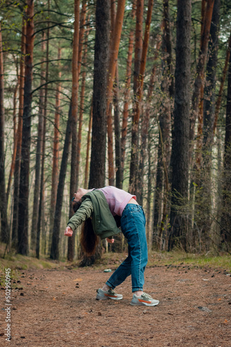 Beautiful young girl dancing in the forest dance