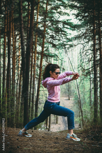 Woman practice Tai Chi Chuan in a park. Chinese management skill Qi's energy. solo outdoor activities. Social Distancing