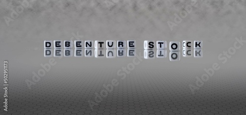 debenture stock word or concept represented by black and white letter cubes on a grey horizon background stretching to infinity
