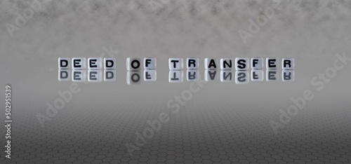 deed of transfer word or concept represented by black and white letter cubes on a grey horizon background stretching to infinity