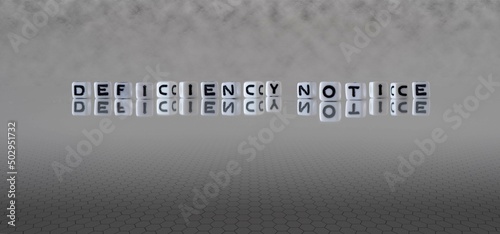 deficiency notice word or concept represented by black and white letter cubes on a grey horizon background stretching to infinity